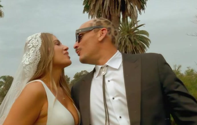Couple close together in the sun after their ceremony